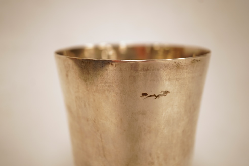 A white metal beaker the base inset with a silver medal commemorating the Peace of Oliva, 1660, Obv. Bird's-eye view of the city of Danzig with troops moving in foreground; above, an eagle crowned, an olive branch in its